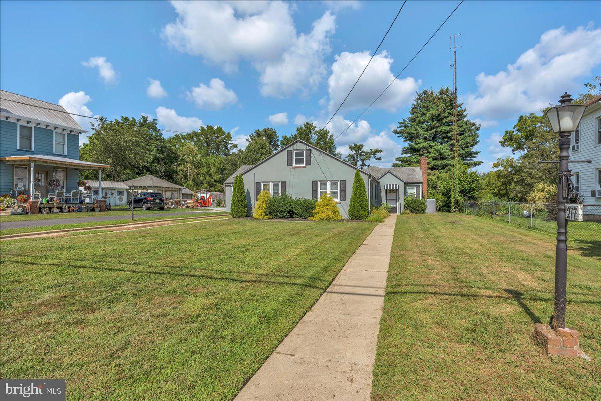217 South Main Street Elmer, NJ 08318 - Photo 2 of 25 a view of house with garden