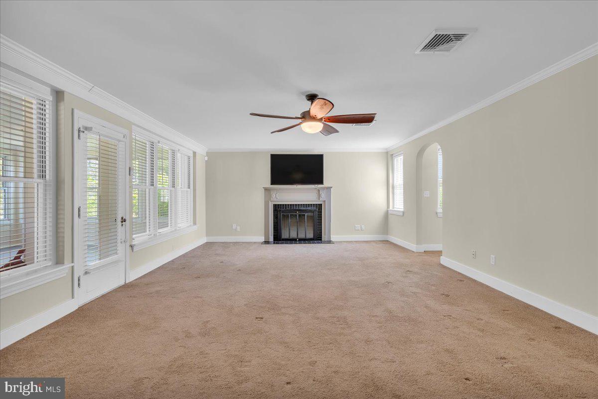 217 South Main Street Elmer, NJ 08318 - Photo 4 of 25 a view of an empty room with a fireplace and a window