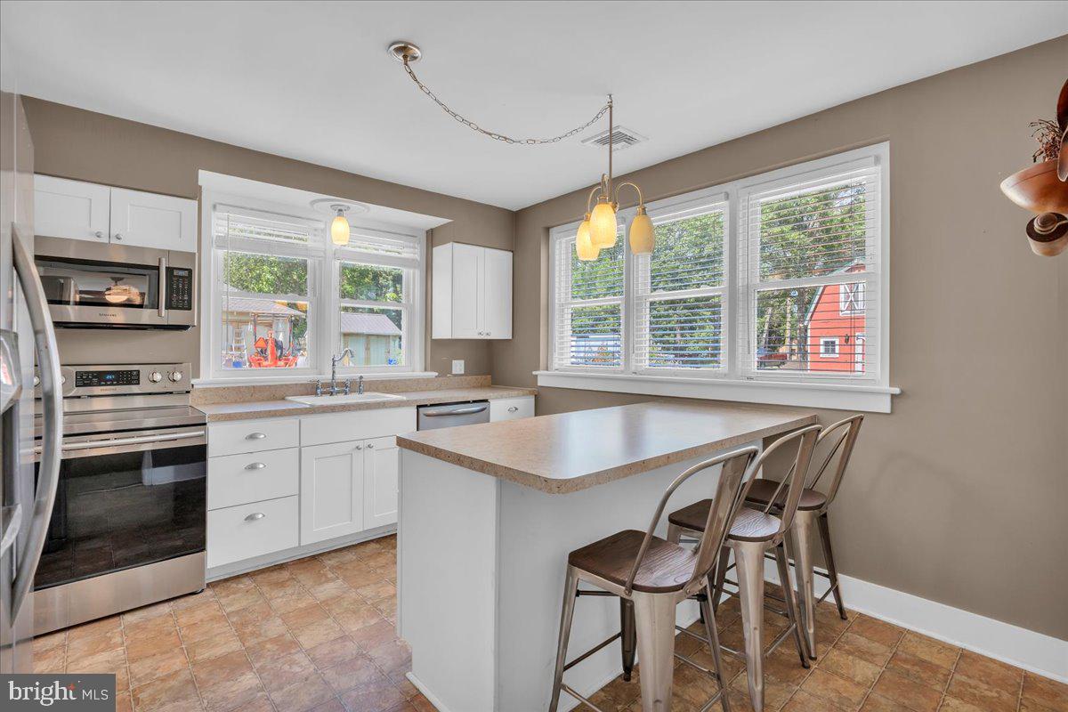 217 South Main Street Elmer, NJ 08318 - Photo 6 of 25 a open kitchen with stainless steel appliances granite countertop a stove a sink and a refrigerator