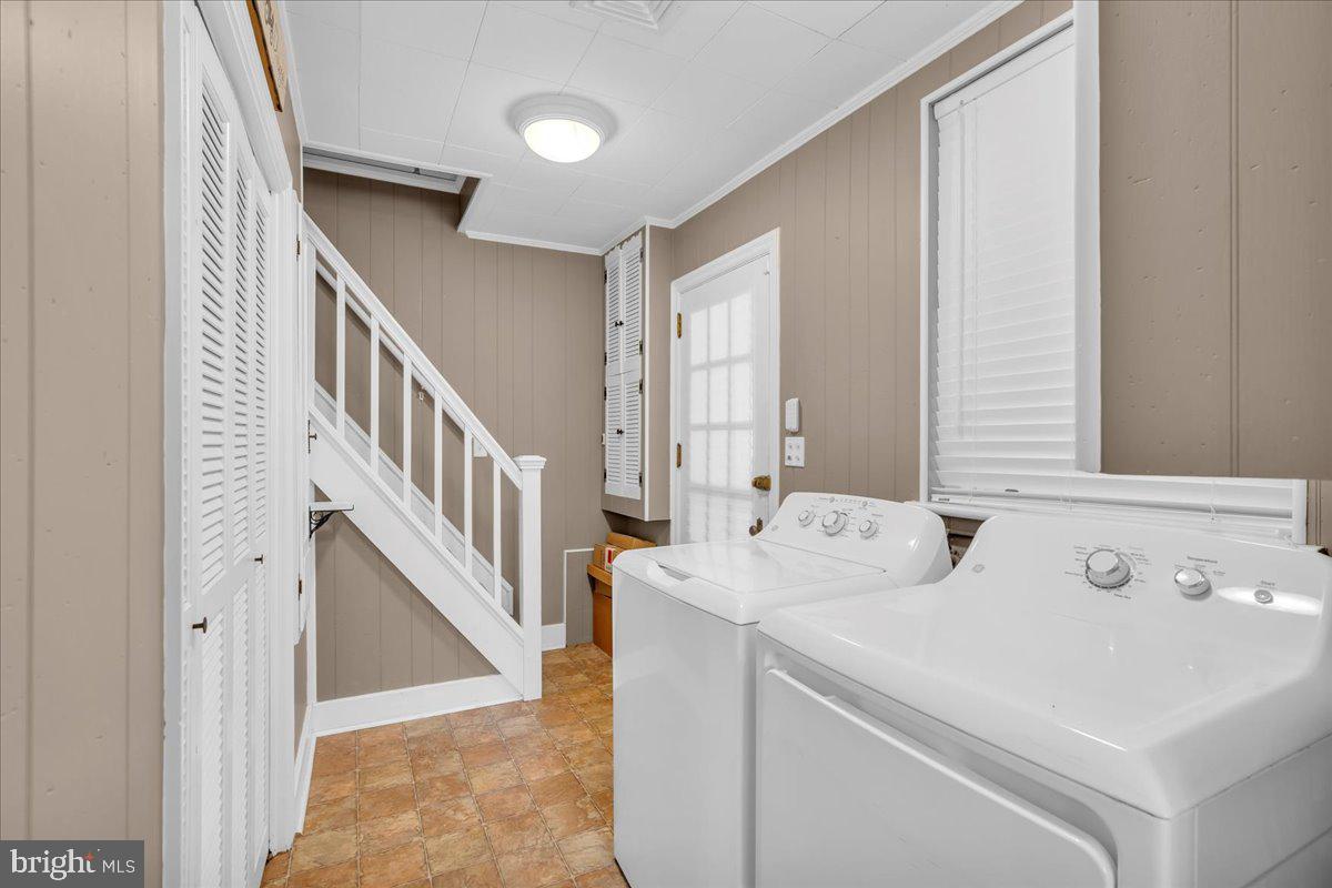217 South Main Street Elmer, NJ 08318 - Photo 10 of 25 a view of washer and dryer with bathroom in the background