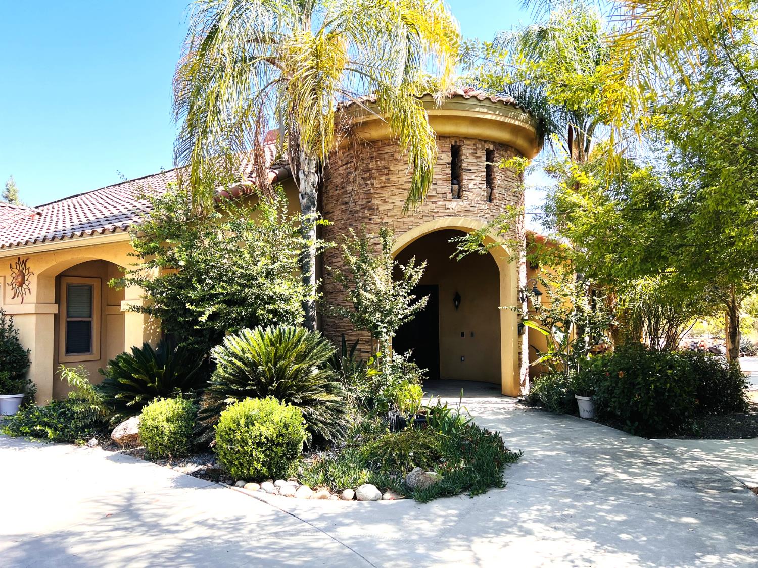 a front view of a house with a garden