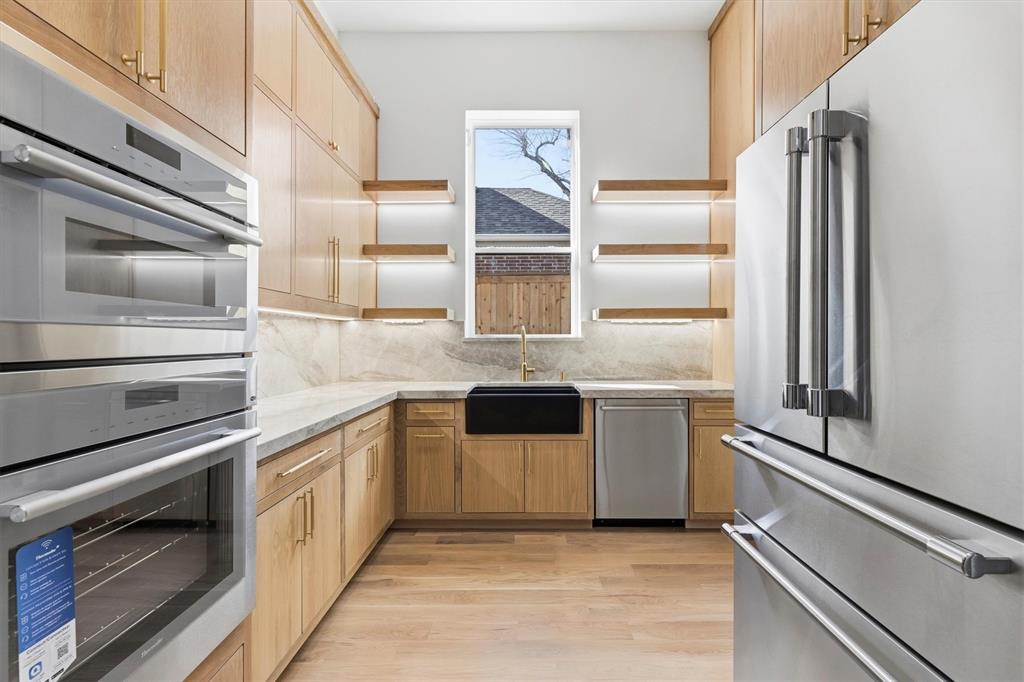 6257 Turner Way Dallas, TX 75230 - Photo 11 of 39 a kitchen with a refrigerator and a stove