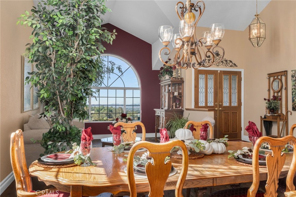 10684 Lakeview Road Yucaipa, CA 92399 - Photo 16 of 63 a view of a dining room with furniture a chandelier and window