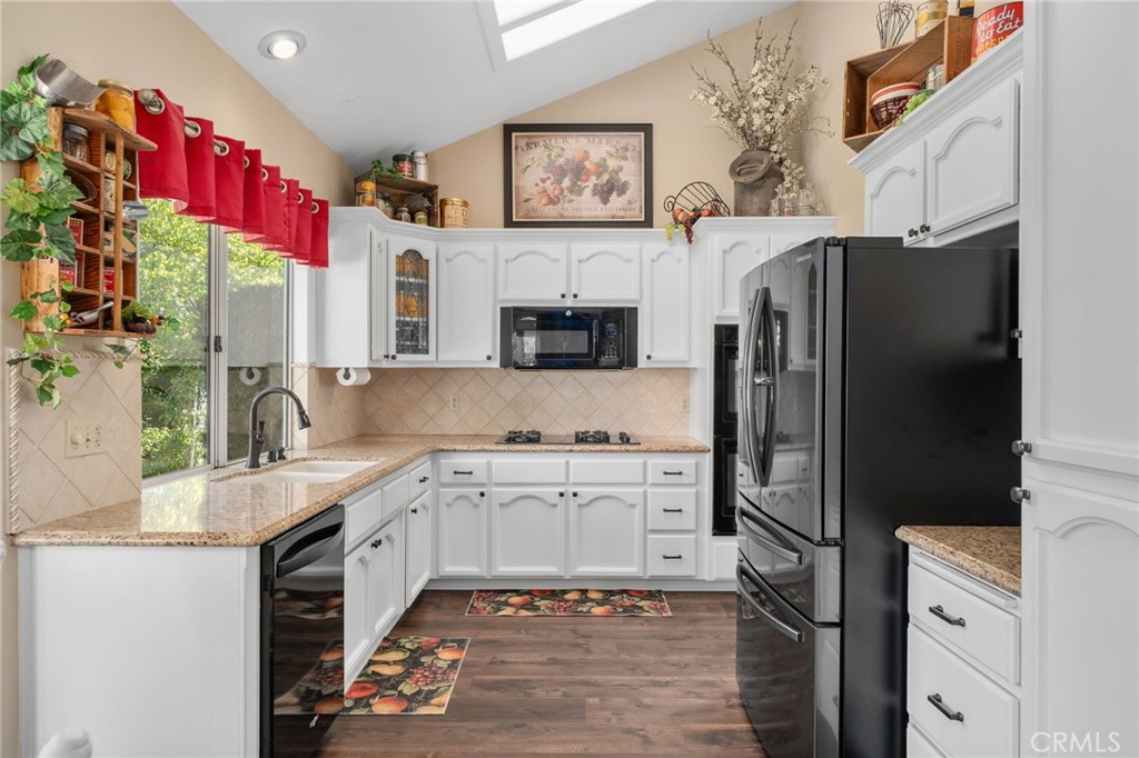 10684 Lakeview Road Yucaipa, CA 92399 - Photo 18 of 63 a kitchen with stainless steel appliances a stove refrigerator and a sink