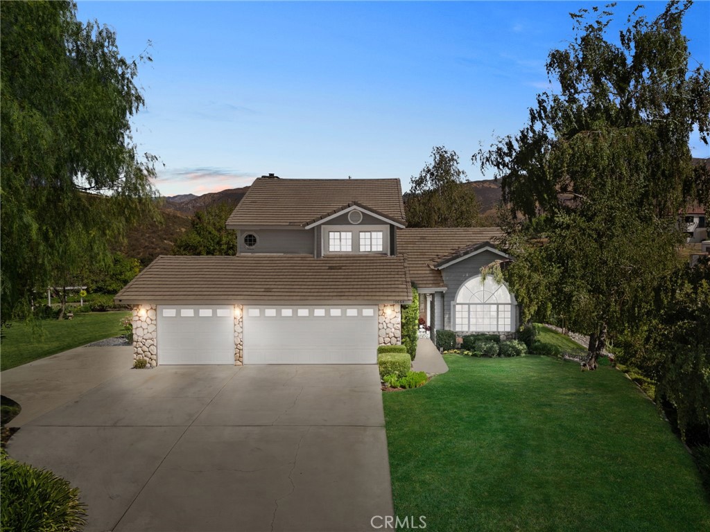 10684 Lakeview Road Yucaipa, CA 92399 - Photo 2 of 63 a view of a big house with a big yard and large trees