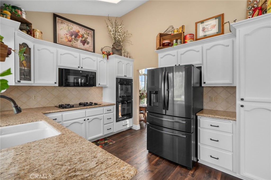 10684 Lakeview Road Yucaipa, CA 92399 - Photo 21 of 63 a kitchen with stainless steel appliances granite countertop a refrigerator stove and sink