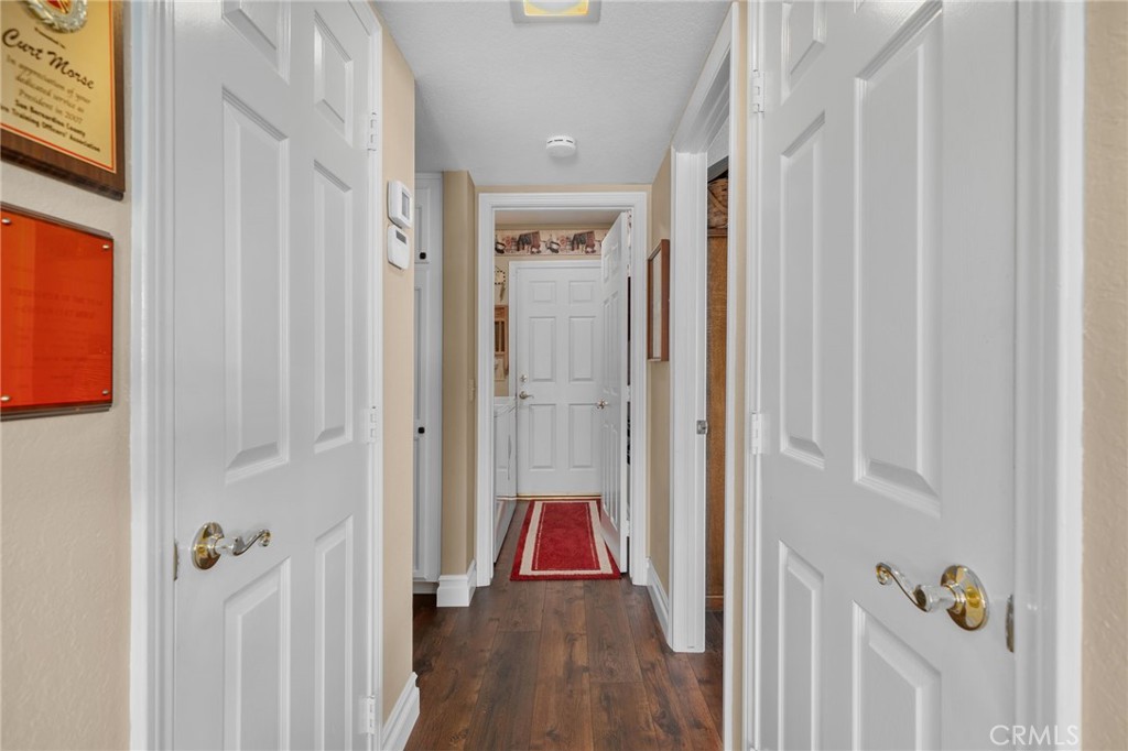 10684 Lakeview Road Yucaipa, CA 92399 - Photo 30 of 63 a view of a hallway with wooden floor and closet
