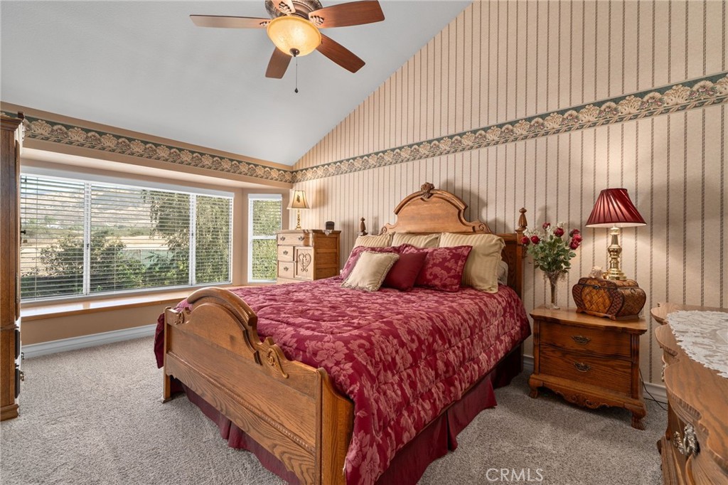 10684 Lakeview Road Yucaipa, CA 92399 - Photo 37 of 63 a bed sitting in a room next to a lamp