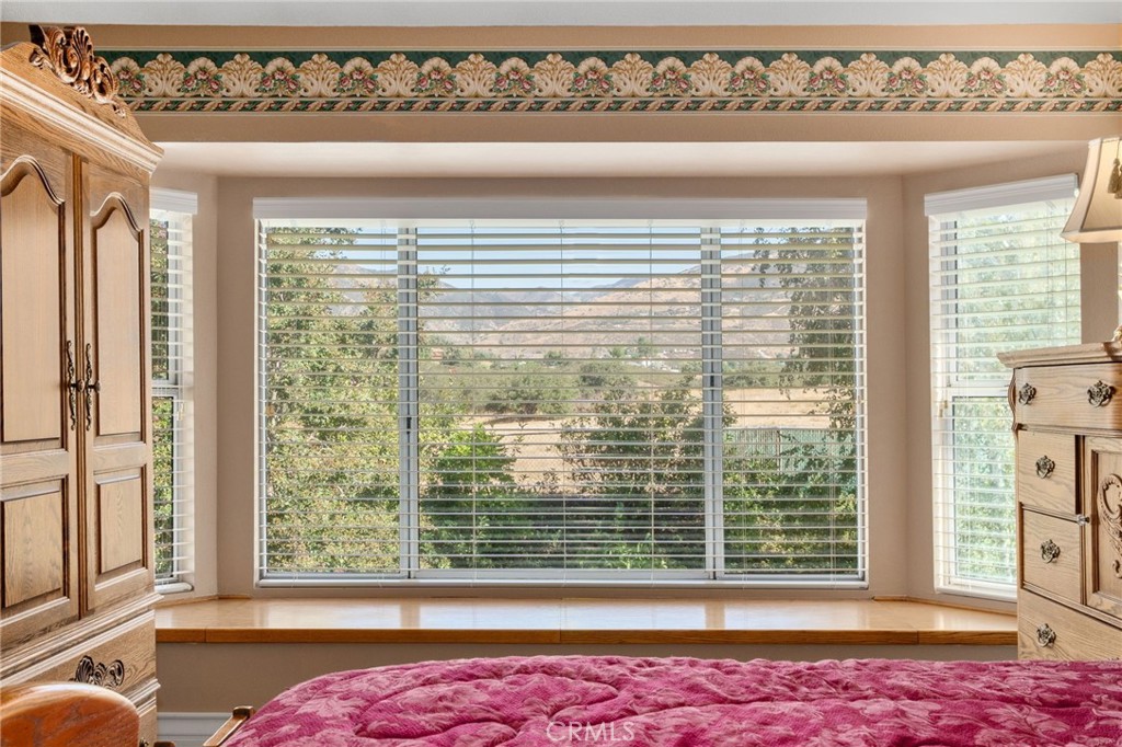 10684 Lakeview Road Yucaipa, CA 92399 - Photo 38 of 63 a view of an empty room with wooden floor and a window