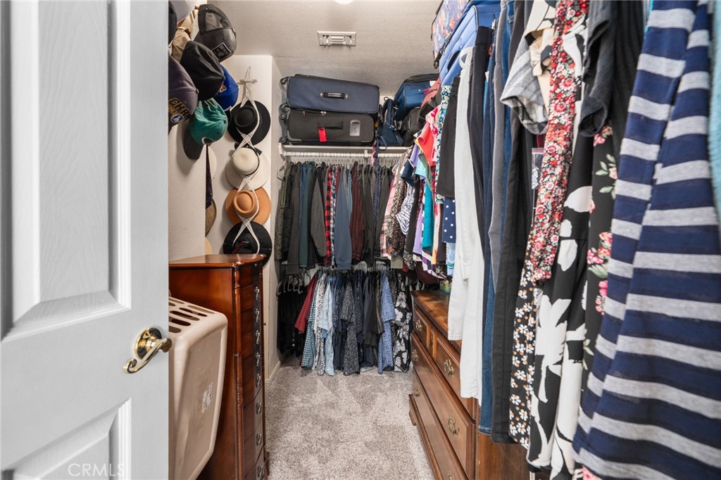 10684 Lakeview Road Yucaipa, CA 92399 - Photo 43 of 63 a view of walk in closet with clothes and shoes