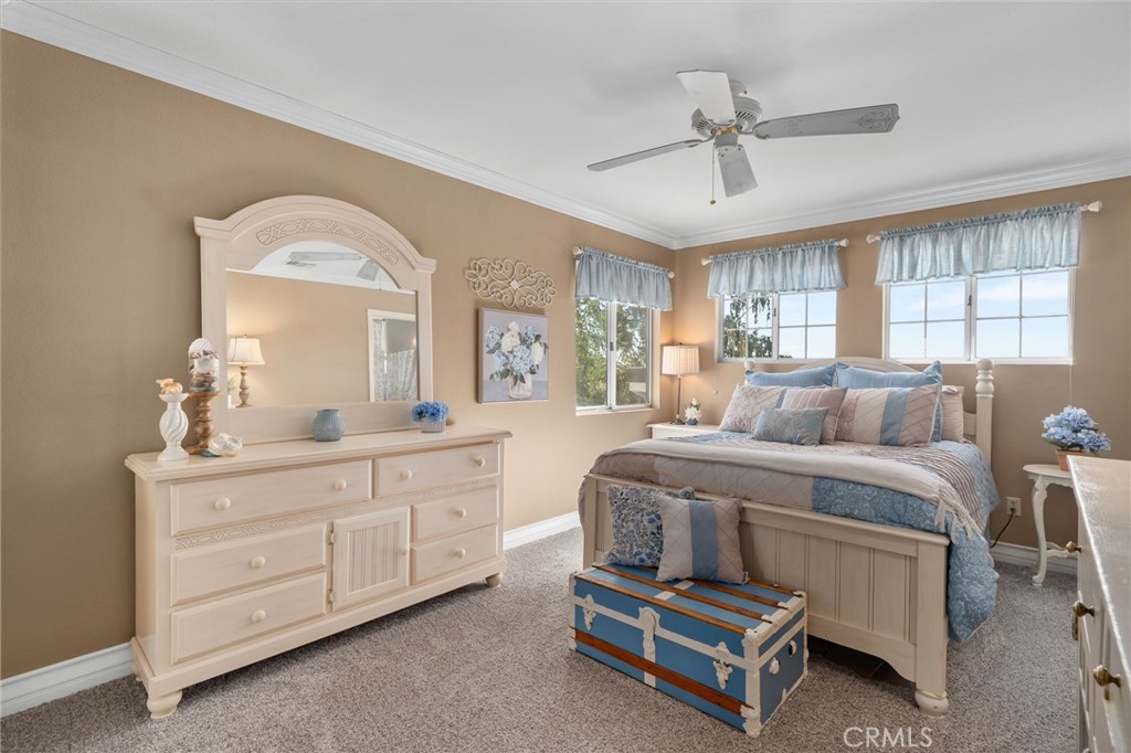 10684 Lakeview Road Yucaipa, CA 92399 - Photo 44 of 63 a spacious bedroom with a bed a window and mirror