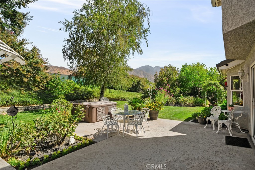 10684 Lakeview Road Yucaipa, CA 92399 - Photo 54 of 63 a view of a patio with table and chairs potted plants and large tree