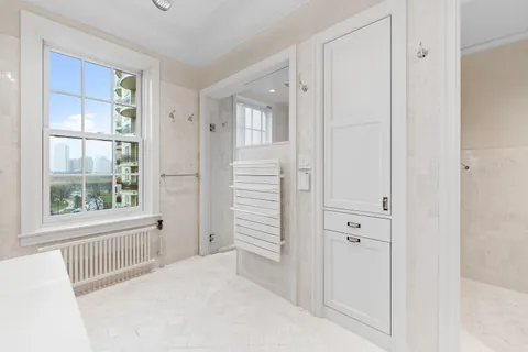 a spacious bedroom with a bed and a chandelier