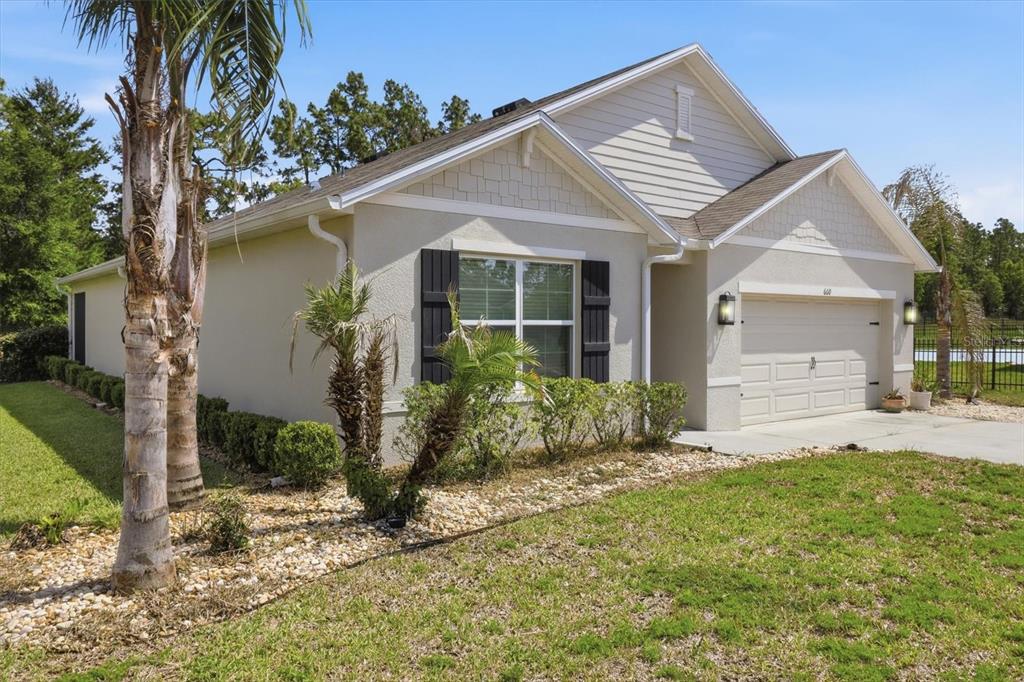 660 Hickory Course Loop Ocala, FL 34472 - Photo 3 of 45 a front view of a house with garden