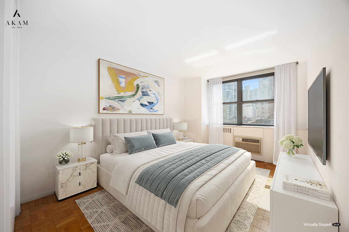 239 East 79th Street, Unit 8A Manhattan, NY 10075 - Photo 10 of 14 a bedroom with a bed and a flat screen tv