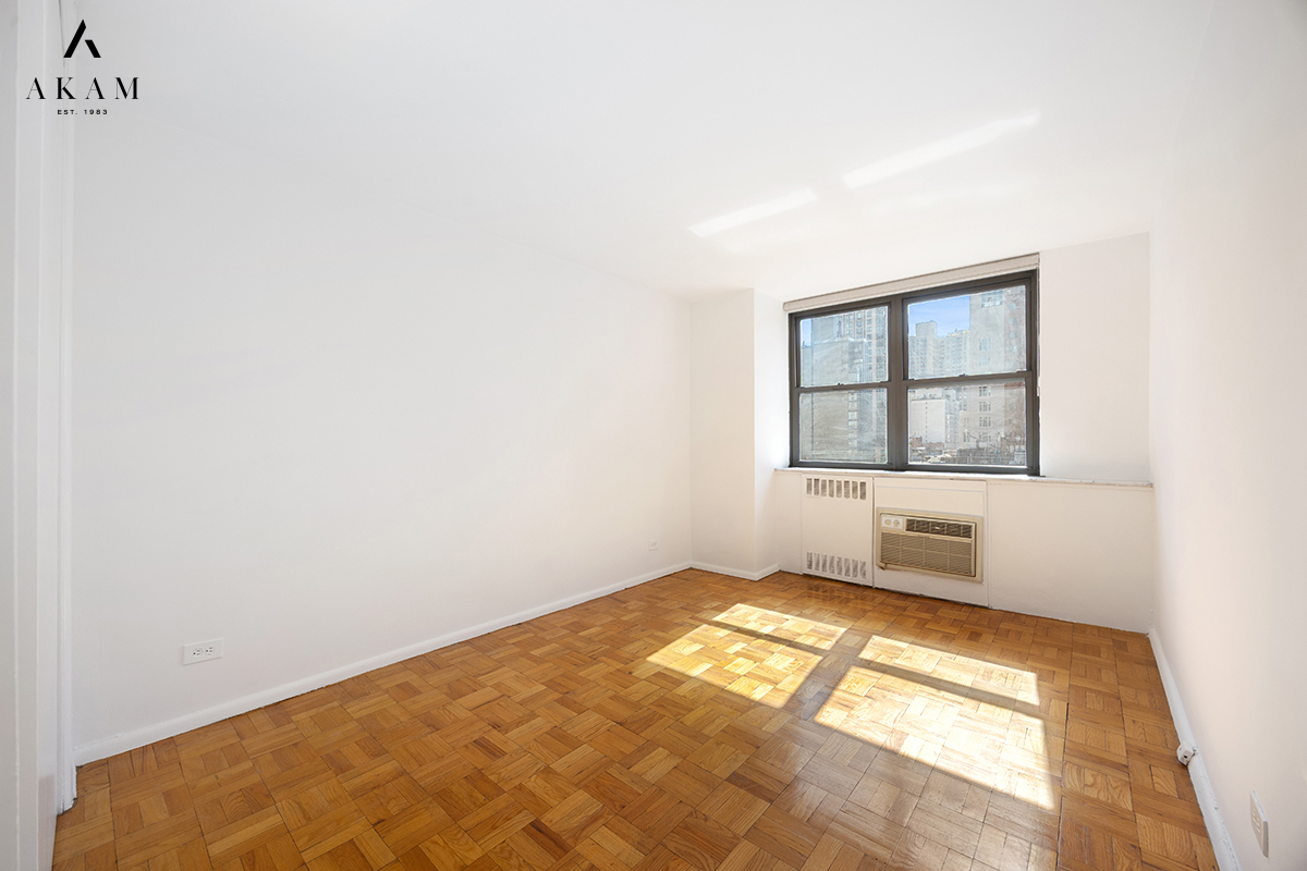 239 East 79th Street, Unit 8A Manhattan, NY 10075 - Photo 11 of 14 an empty room with windows