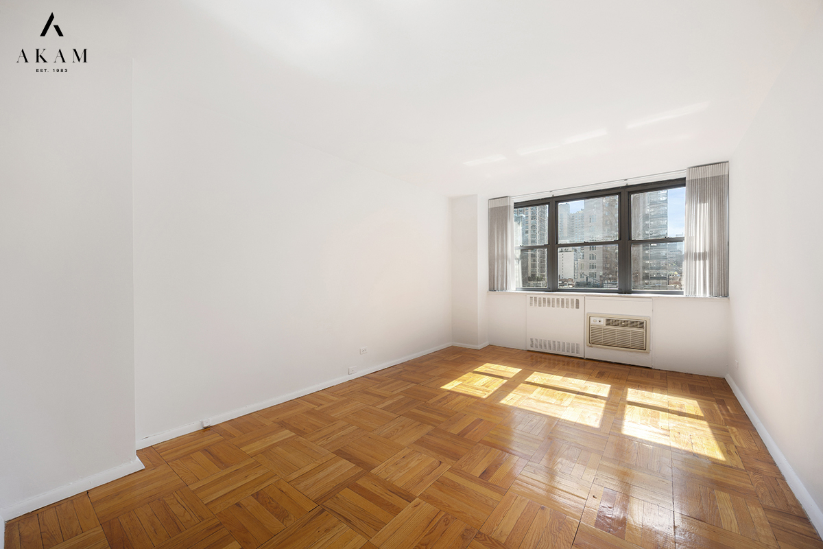 239 East 79th Street, Unit 8A Manhattan, NY 10075 - Photo 9 of 14 a view of an empty room and window