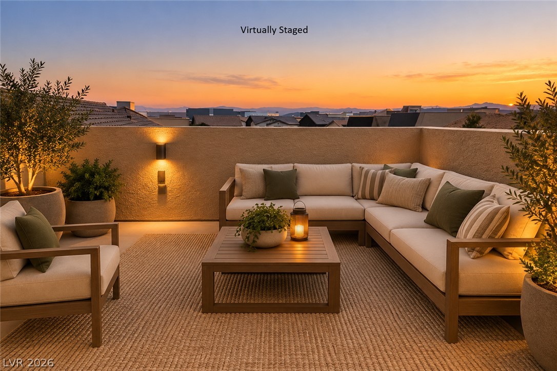 8059 Encanterra Road Las Vegas, NV 89113 - Photo 38 of 52 An elevated patio terrace captures distant mountain silhouettes during sunset.