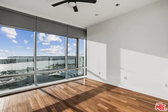 a view of a living room hardwood floor and kitchen view