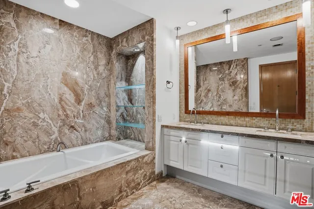 a bathroom with a granite countertop sink a bathtub and shower
