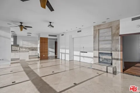 a living room with furniture and a ceiling fan