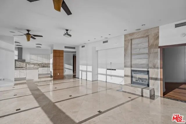 a living room with furniture and a ceiling fan