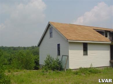 6376 Blueberry Road Stroudsburg, PA 18360 - Photo 3 of 12 a view of a house with a yard