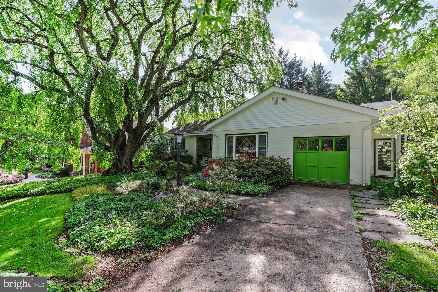 406 Pershing Drive Silver Spring, MD 20910 - Photo 24 of 27 a front view of a house with a garden