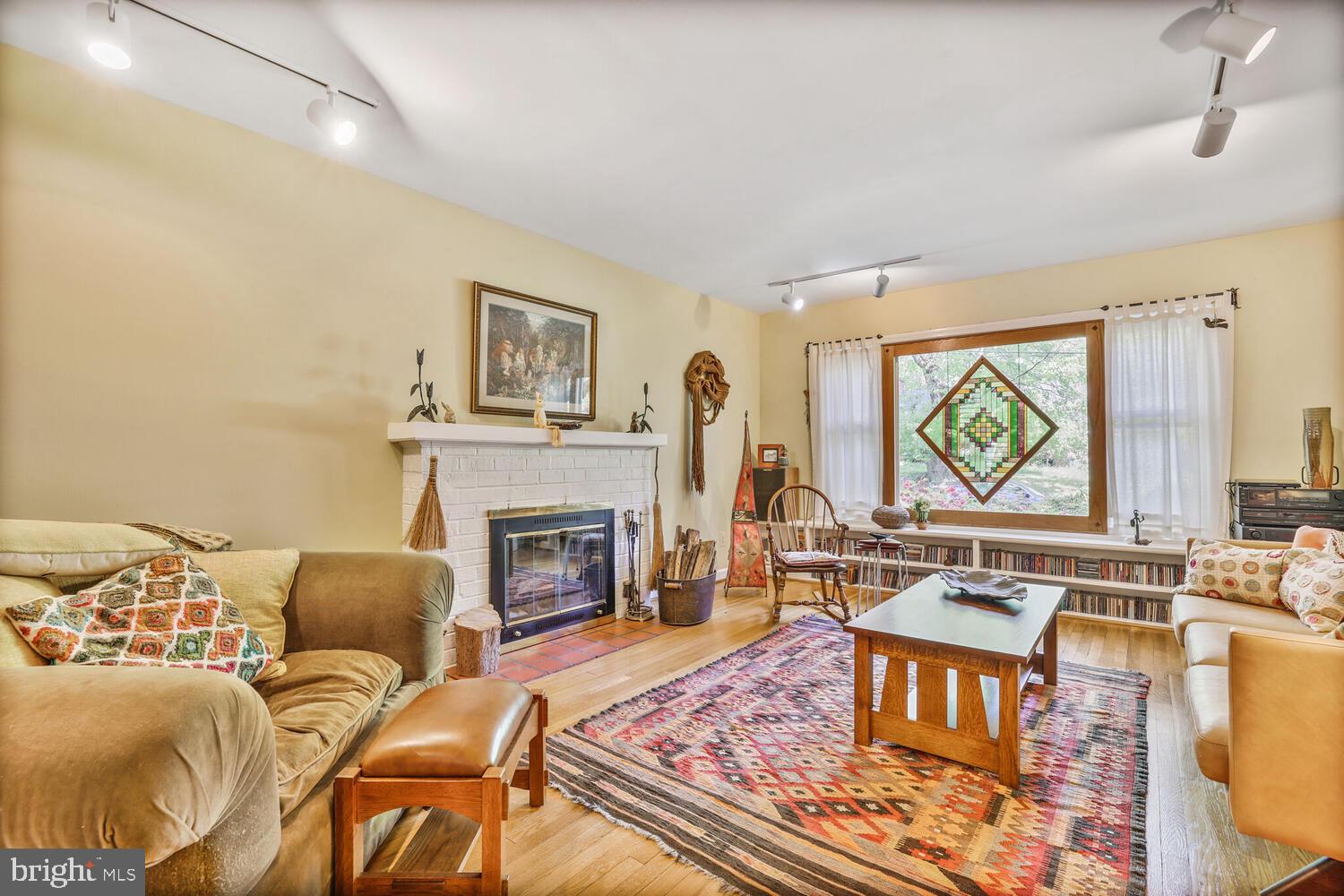 406 Pershing Drive Silver Spring, MD 20910 - Photo 4 of 27 a living room with furniture a fireplace and a table