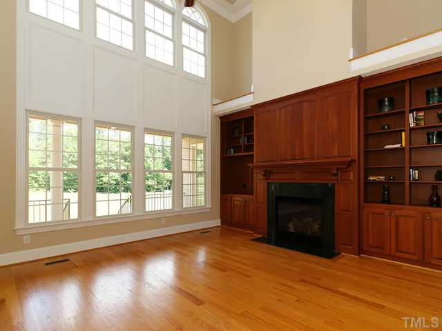1084 Tacketts Pond Drive Raleigh, NC 27614 - Photo 4 of 25 Wall of windows allows plenty of natural light into the spacious family room with custom built-ins.