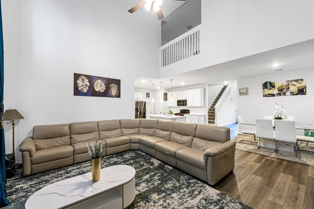 a living room with furniture and a chandelier