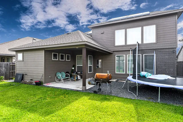 a wooden bench sitting in front of a house