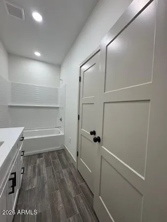 a bedroom with bed window and flowerpot