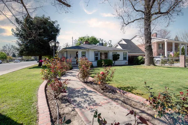 a front view of a house with garden