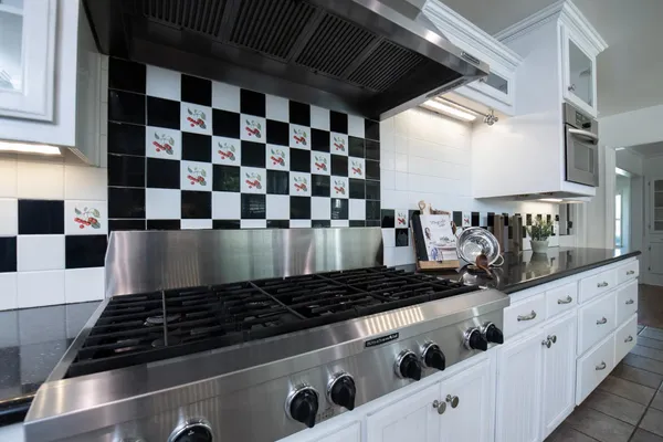 a kitchen with granite countertop stainless steel appliances and cabinets