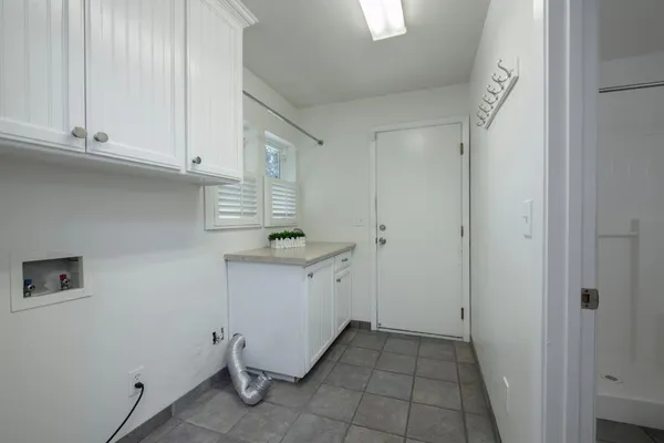 a bathroom with a granite countertop sink mirror vanity and toilet