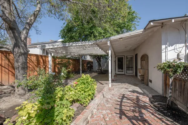 a view of a porch with a table and chairs