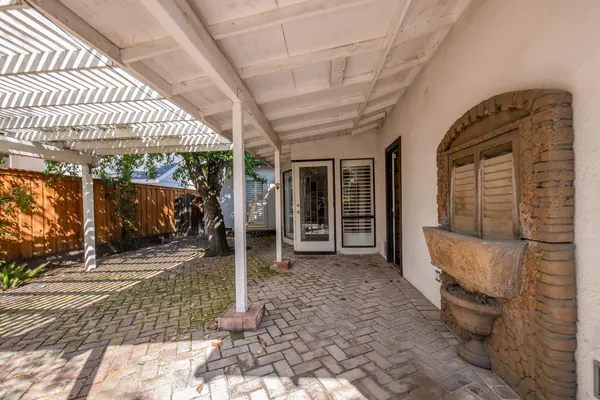 a view of a porch with furniture and floor to ceiling window