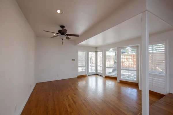 a view of a hallway with wooden floor