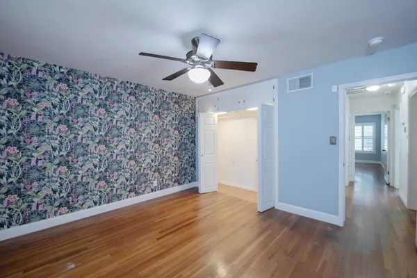 a bathroom with a granite countertop sink a mirror and shower