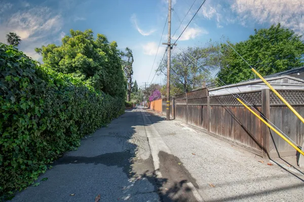 a view of a balcony with floor to ceiling windows and potted plants