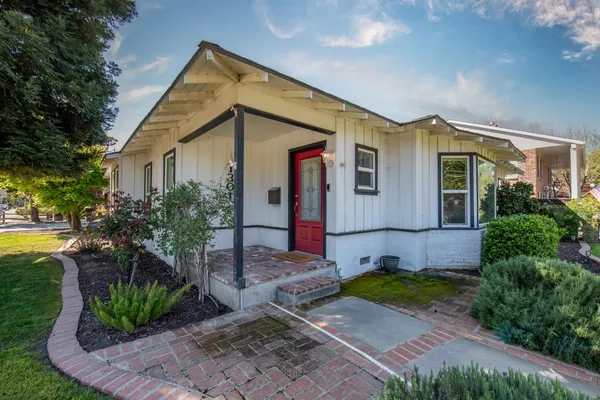a front view of house with yard and green space