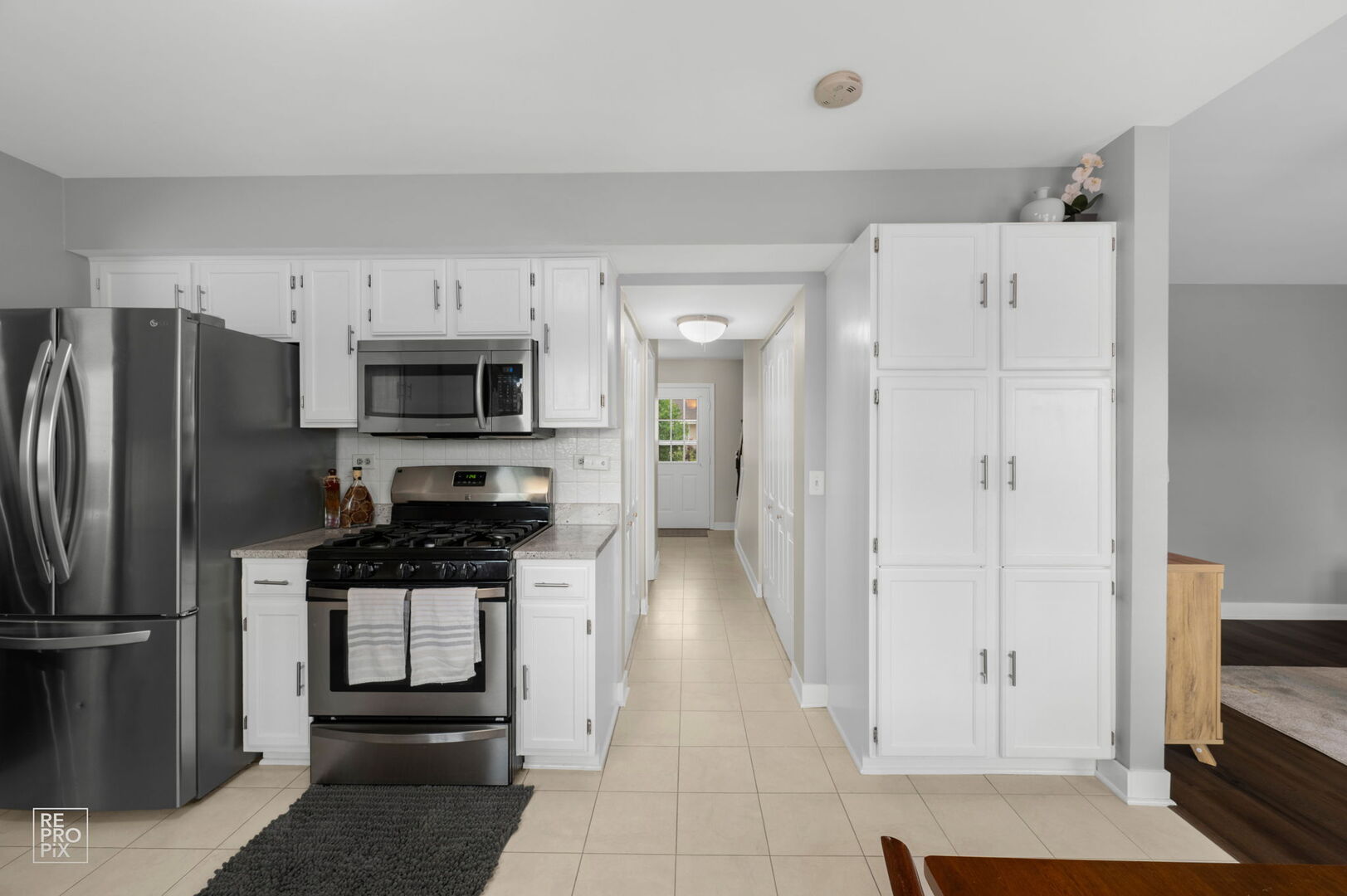 95 North Southport Road Mundelein, IL 60060 - Photo 10 of 26 a kitchen with stainless steel appliances granite countertop a refrigerator and a stove top oven