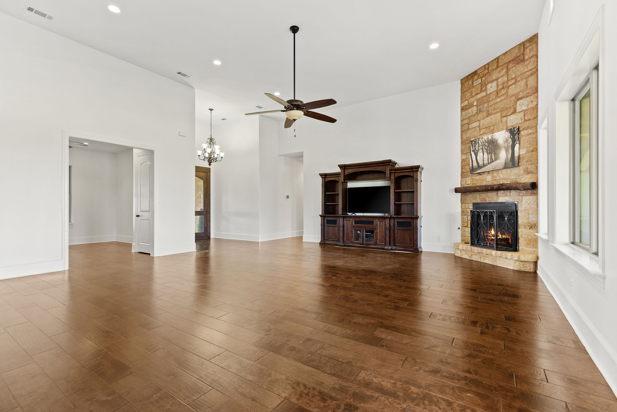 1124 County Road 301 Elgin, TX 78621 - Photo 11 of 40 an empty room with wooden floor fireplace and a window
