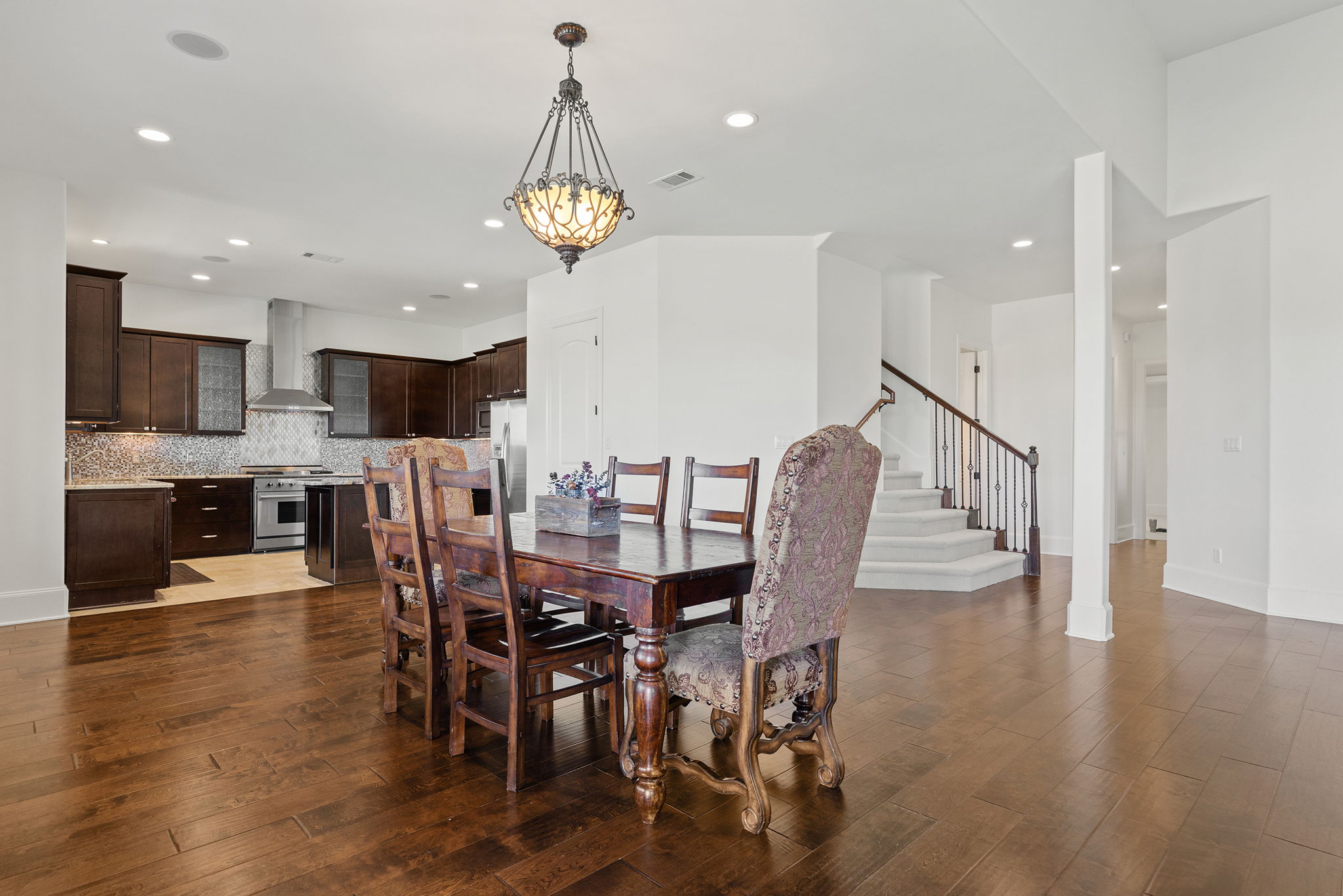 1124 County Road 301 Elgin, TX 78621 - Photo 13 of 40 a view of a dining room and livingroom with furniture wooden floor a chandelier