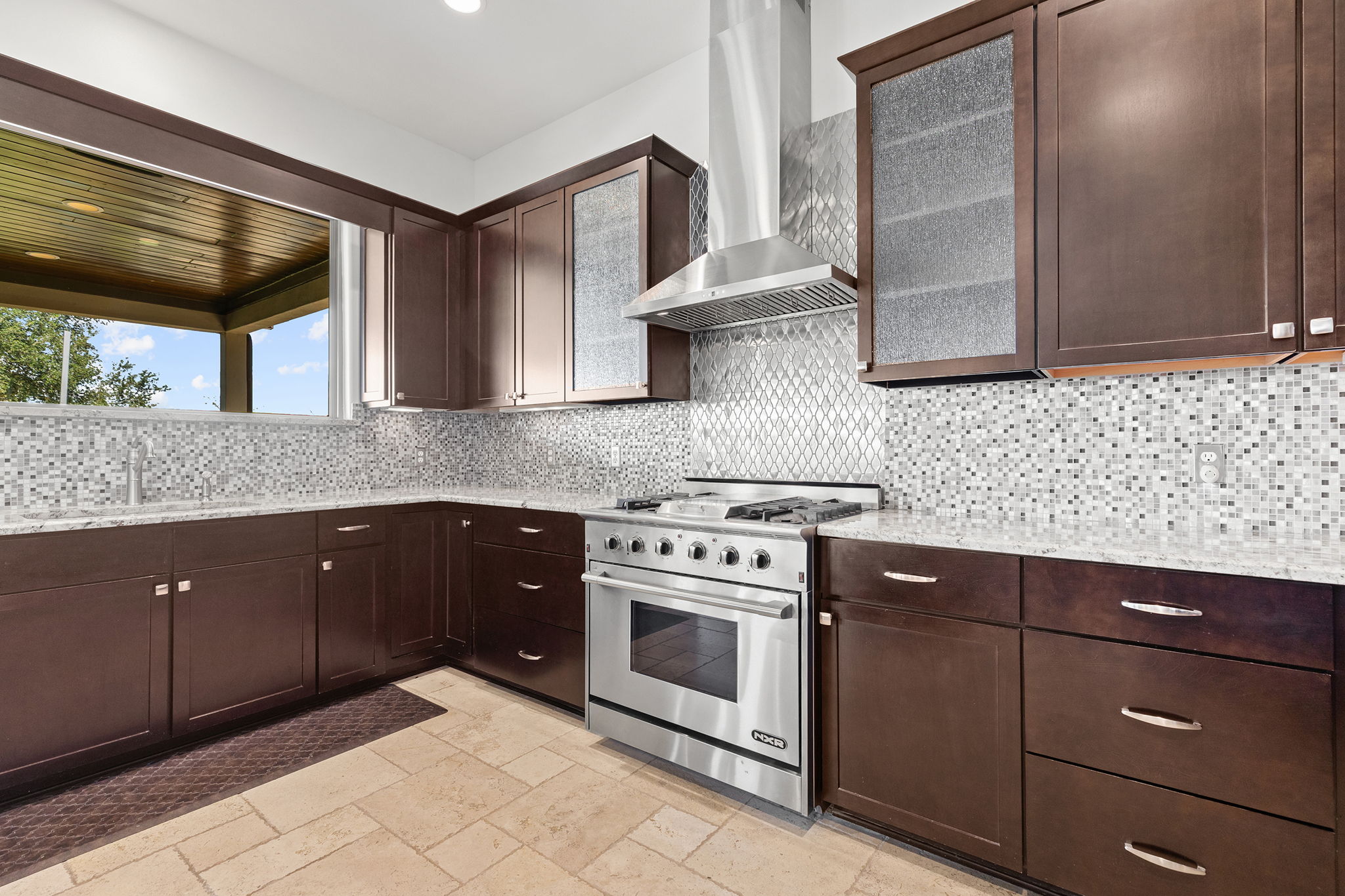 1124 County Road 301 Elgin, TX 78621 - Photo 14 of 40 a kitchen with granite countertop a stove sink and cabinets