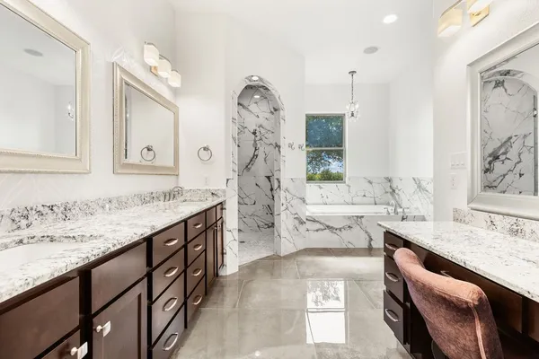 a spacious bathroom with a granite countertop sink and a mirror