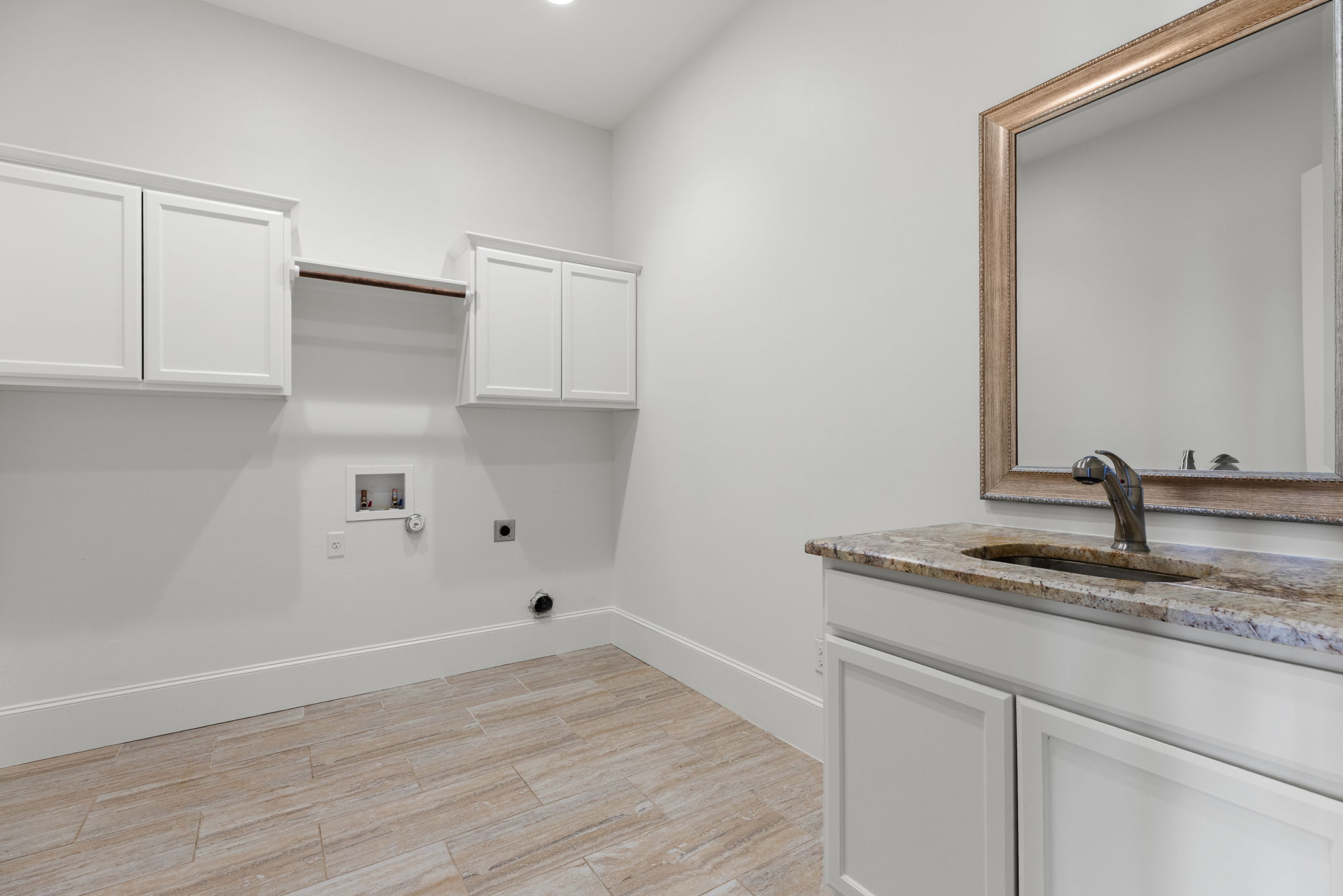 1124 County Road 301 Elgin, TX 78621 - Photo 21 of 40 a kitchen with a sink cabinets and wooden floor