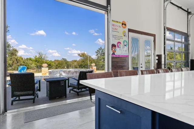 a view of a patio with a table and chairs