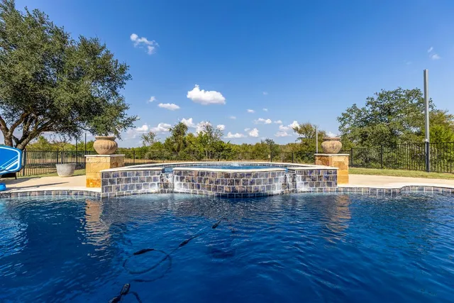 a view of a swimming pool with deck and lake view